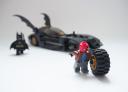 red_hood_stealing_batmobile_tyre.jpg