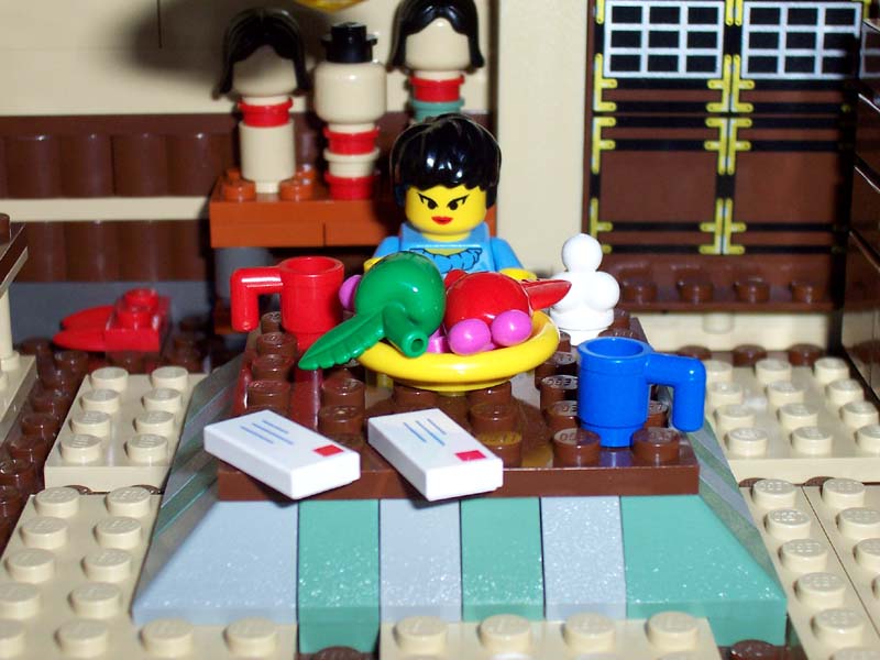 77_mamasan_seated_at_kotatsu.jpg