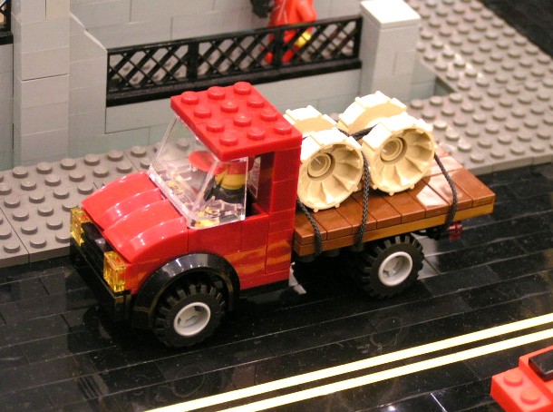 flatbed_truck_hauling_tan_wheels.jpg