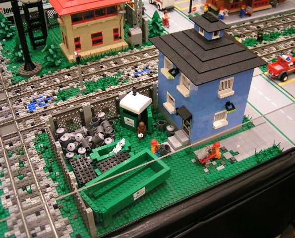 house_with_dumpsters_and_trashcans.jpg