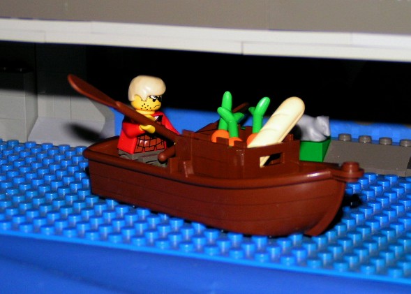 guy_in_boat_under_castle.jpg