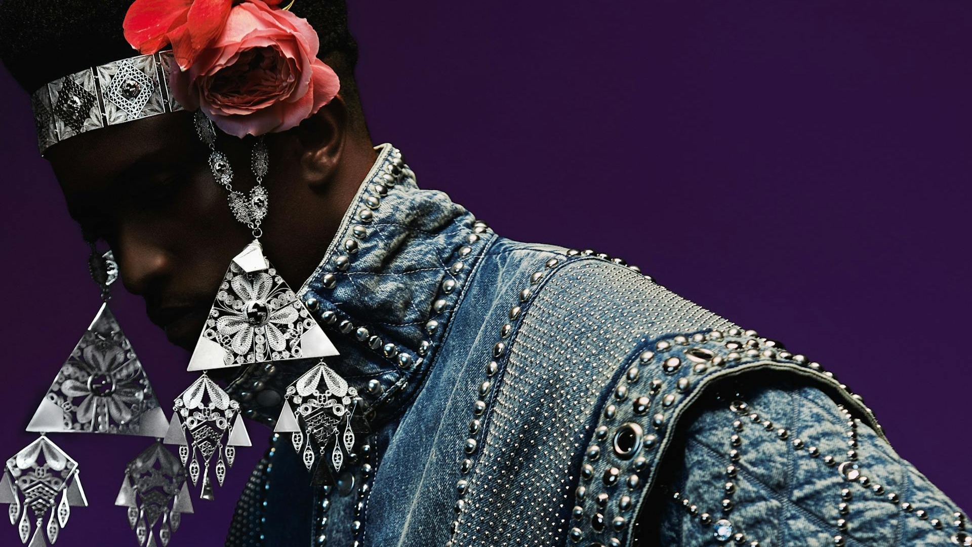 Black man adorned with rose headpiece and silver jewelry