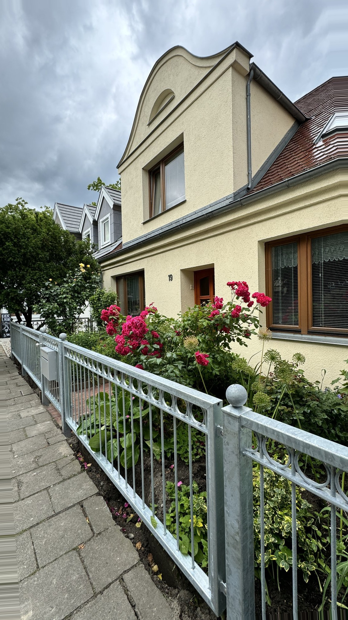Warnemunde Germany Cruise Port - Ornate Peaked Roof Gables Flowering Garden - 05-29-2024 - Vertical.jpg