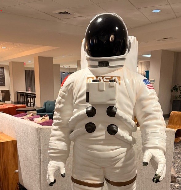 Space Coast themed lobby with a NASA astronaut statue at the Hampton Inn Cape Canaveral