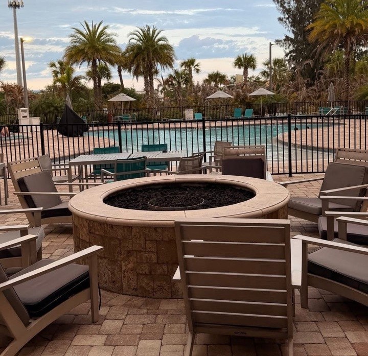 Outdoor pool with sun loungers and a fire pit at the Cape Canaveral cruise port hotel