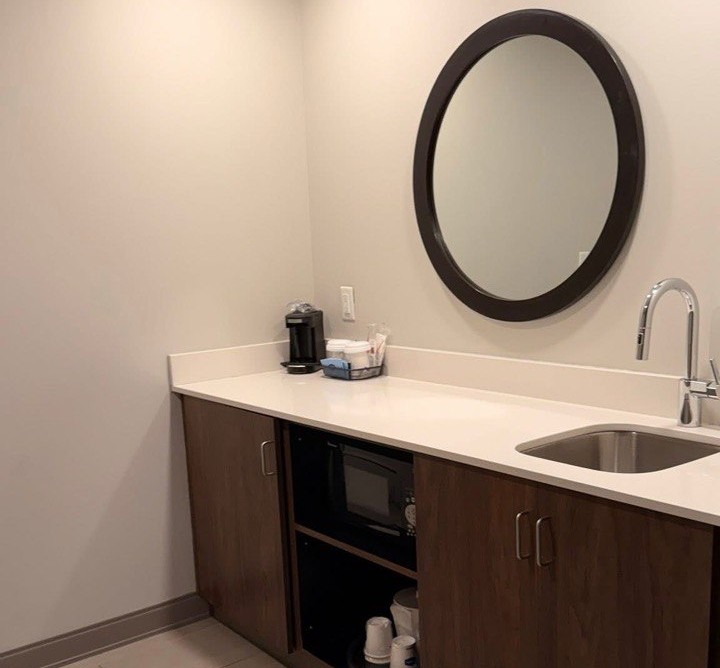 In room kitchenette with a sink, microwave, and mini fridge at the Cape Canaveral cruise port hotel