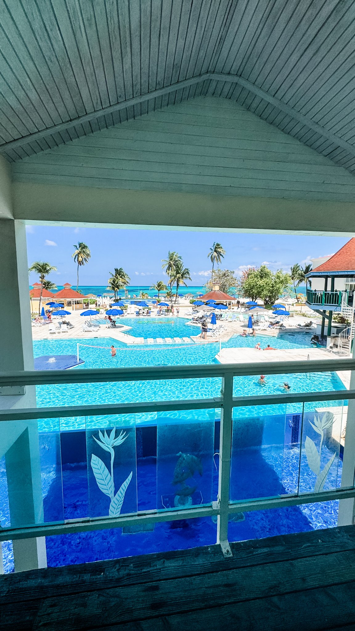 Nassau Cruise Port - Atlantis - Pool and resort area with palm trees and umbrellas - 03-02-2025 - Vertical.jpg