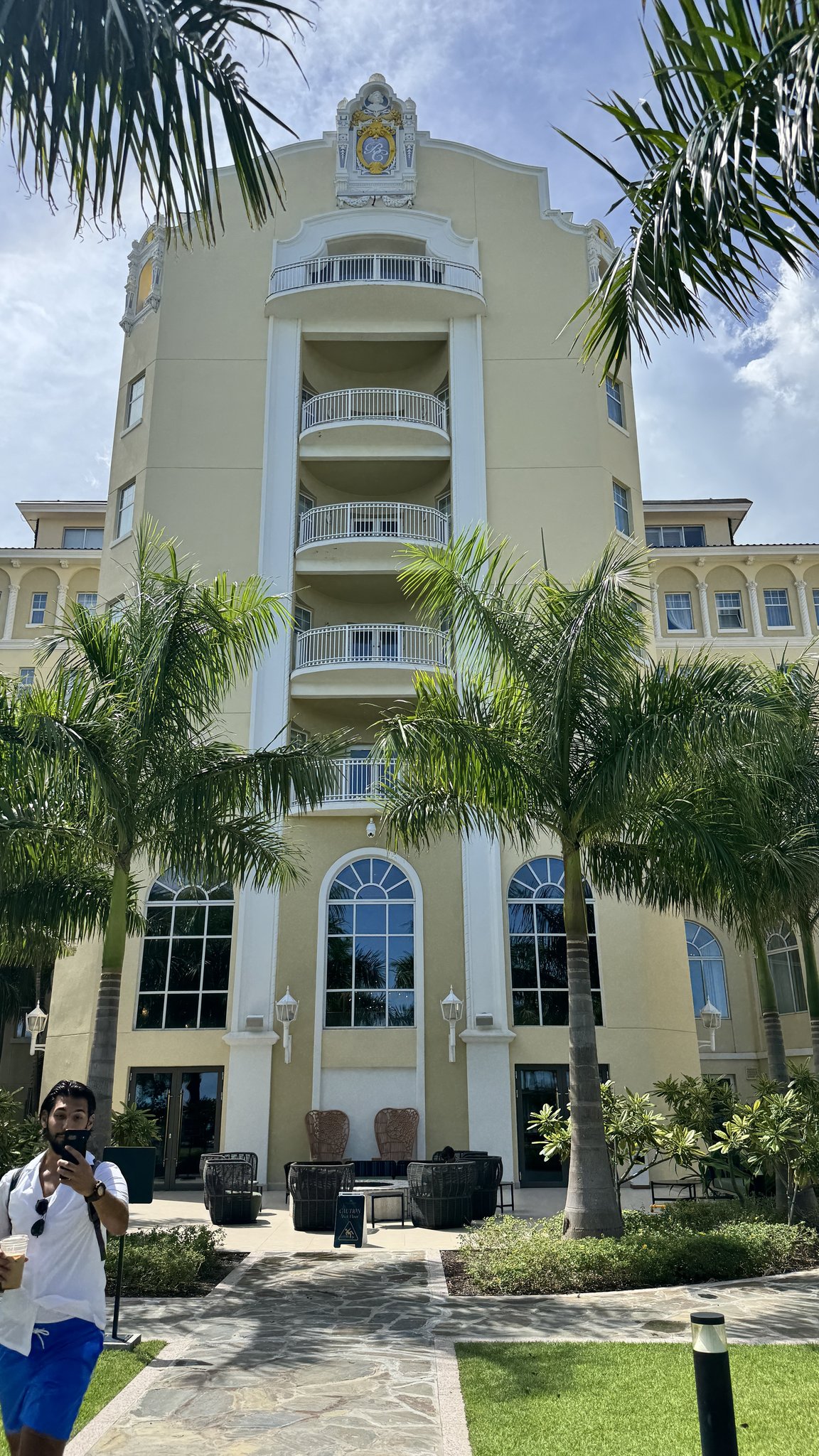 Nassau Cruise Port - Ornate yellow building with palm trees in the - 09-20-2025 - Vertical.jpg