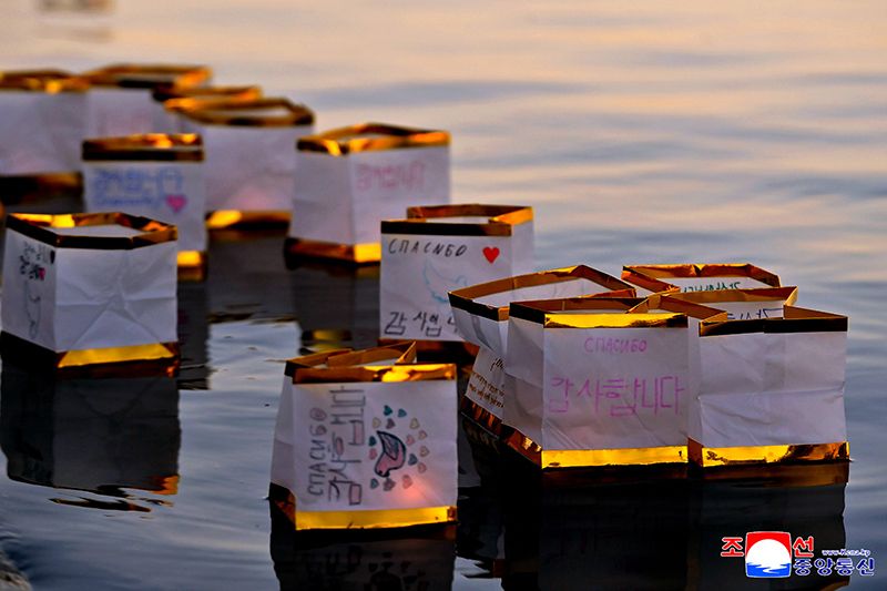 Russian schoolchildren float paper lanterns on Taedong River in Pyongyang