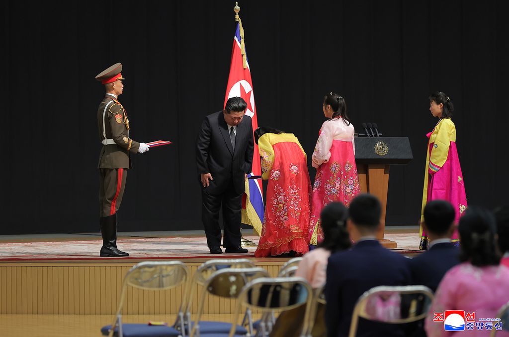 RespectedComrade Kim Jong Un meets bereaved families of martyrs who performed distinguished feats in overseas military operations and has photo session with them - Image 3