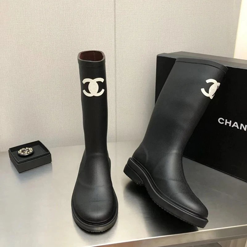 Chanel's iconic CC logo rubber rain boots. qc 1