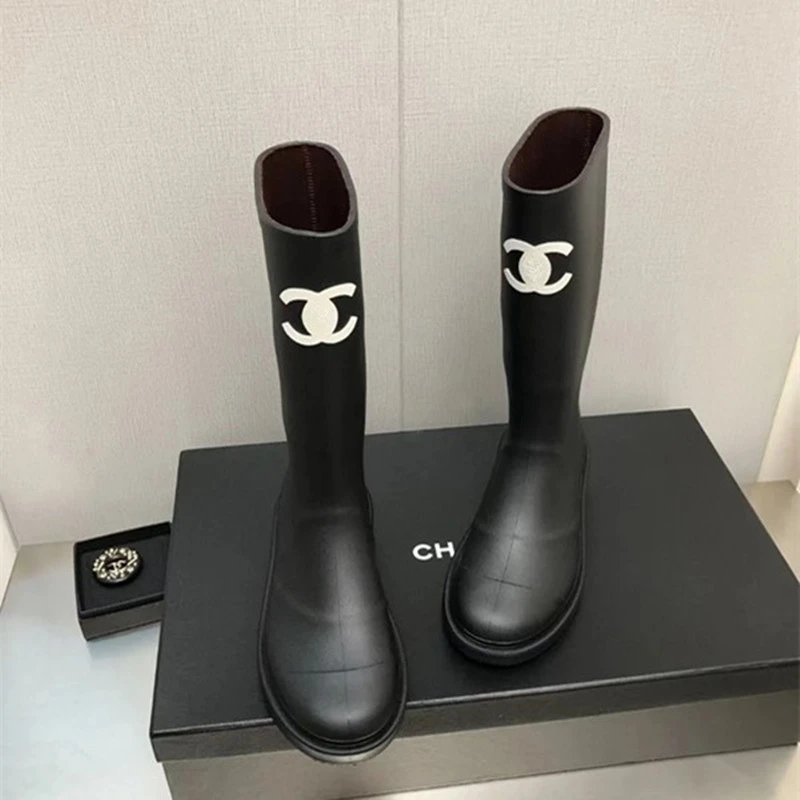 Chanel's iconic CC logo rubber rain boots. qc 2