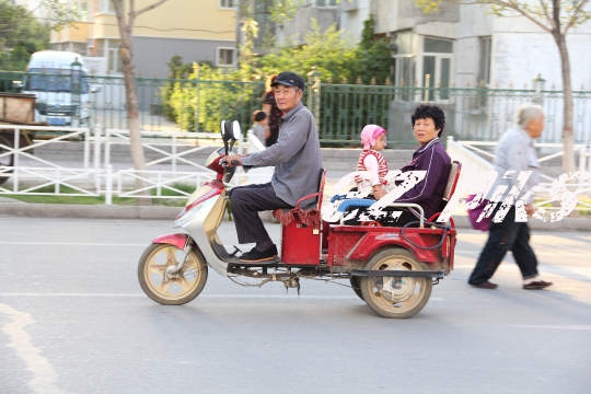 Xinjiang family on a scooter