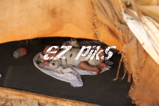 Baby inside Qibb Ilyas refugee camp