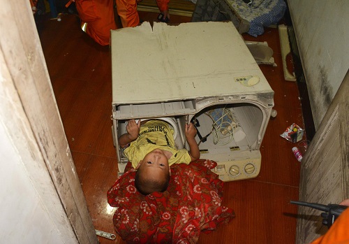 A 3-year-old boy is seen stuck in the cylinder of a washing machine as firefighters carry out rescue operations in Yongjia county of Wenzhou