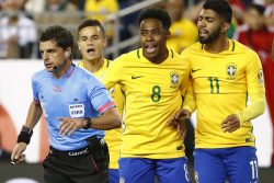 Jun 12, 2016; Foxborough, MA, USA; Brazil forward Gabriel (11) and midfielder Elias (8) and midfielder Philippe Coutinho (22) argue with referee Andres Cunha during the first half of the group play stage of the 2016 Copa America Centenario at Gillette Stadium. Mandatory Credit: Winslow Townson-USA TODAY Sports