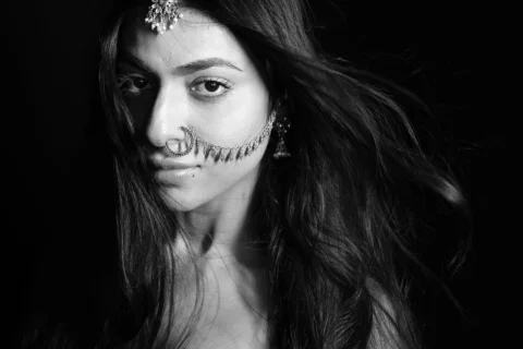 She wears silence like jewellery,
eyes holding stories older than words.
Traditi