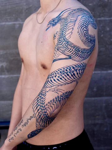 Dragons, snake skeleton blue 🌀
.
#oozy #tattoo