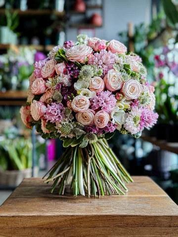 Soft as a whisper, this bouquet brings together blush roses, pink hyacinths, and