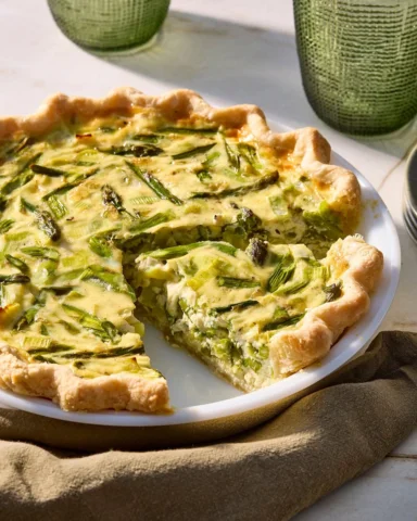 Bursting with spring produce, this leek and asparagus quiche is the perfect way 