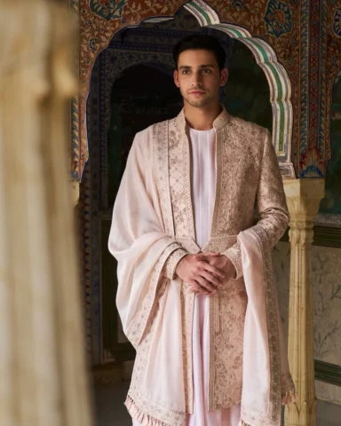 A pastel-pink Jaipur raw silk sherwani, embroidered with intricate resham and pe