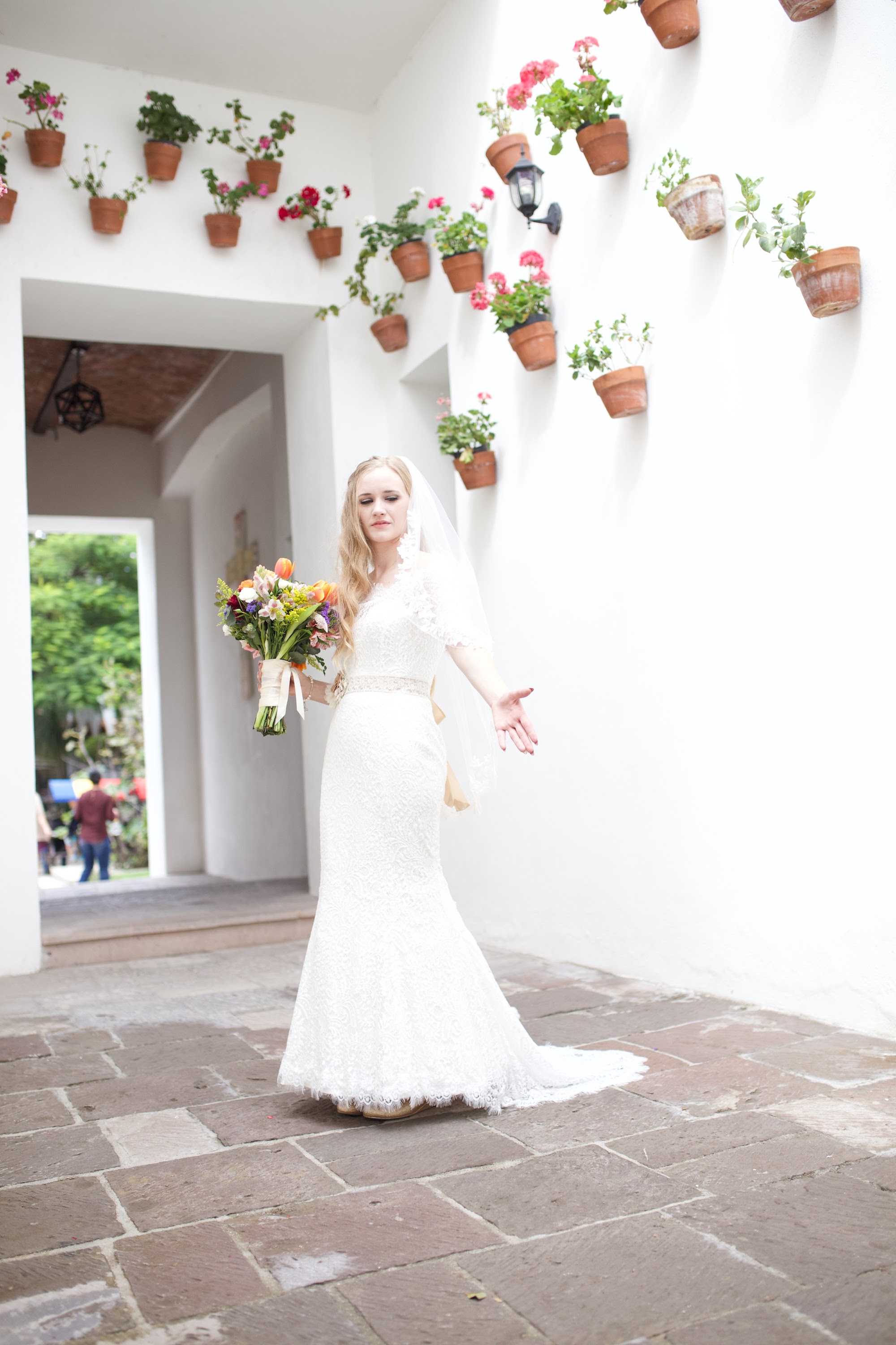 Bride in Lace Wedding Dress Holding Bouquet