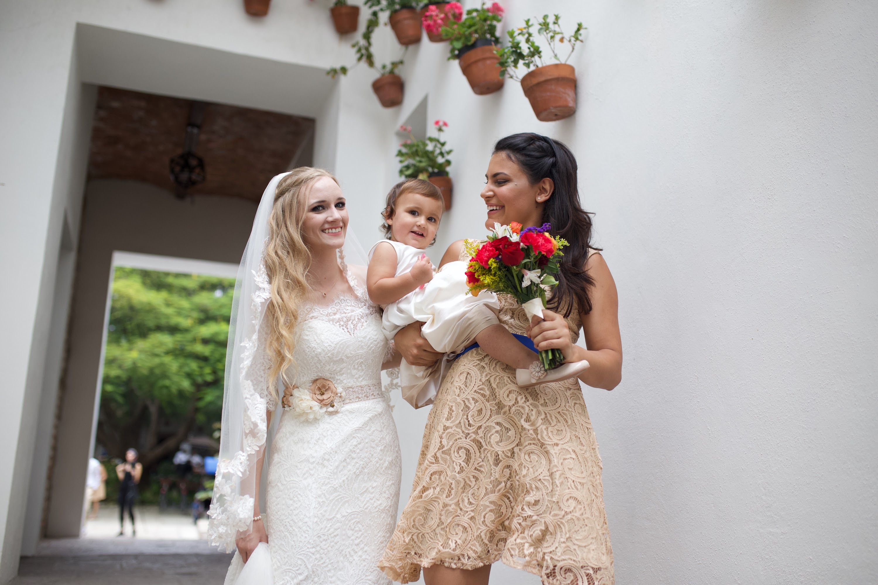 Bride, Bridesmaid, and Child Sharing a Joyful Moment