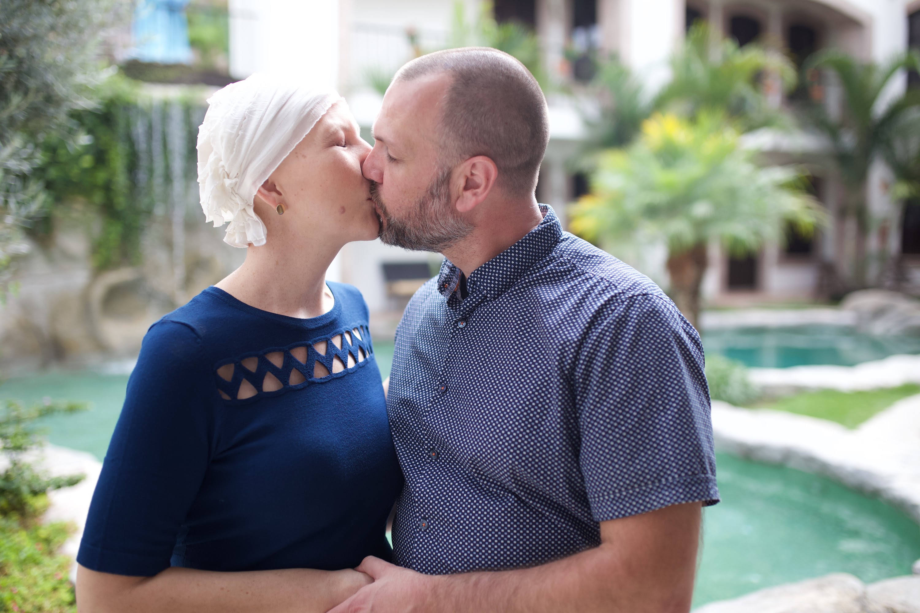 Couple Sharing a Kiss by the Pool