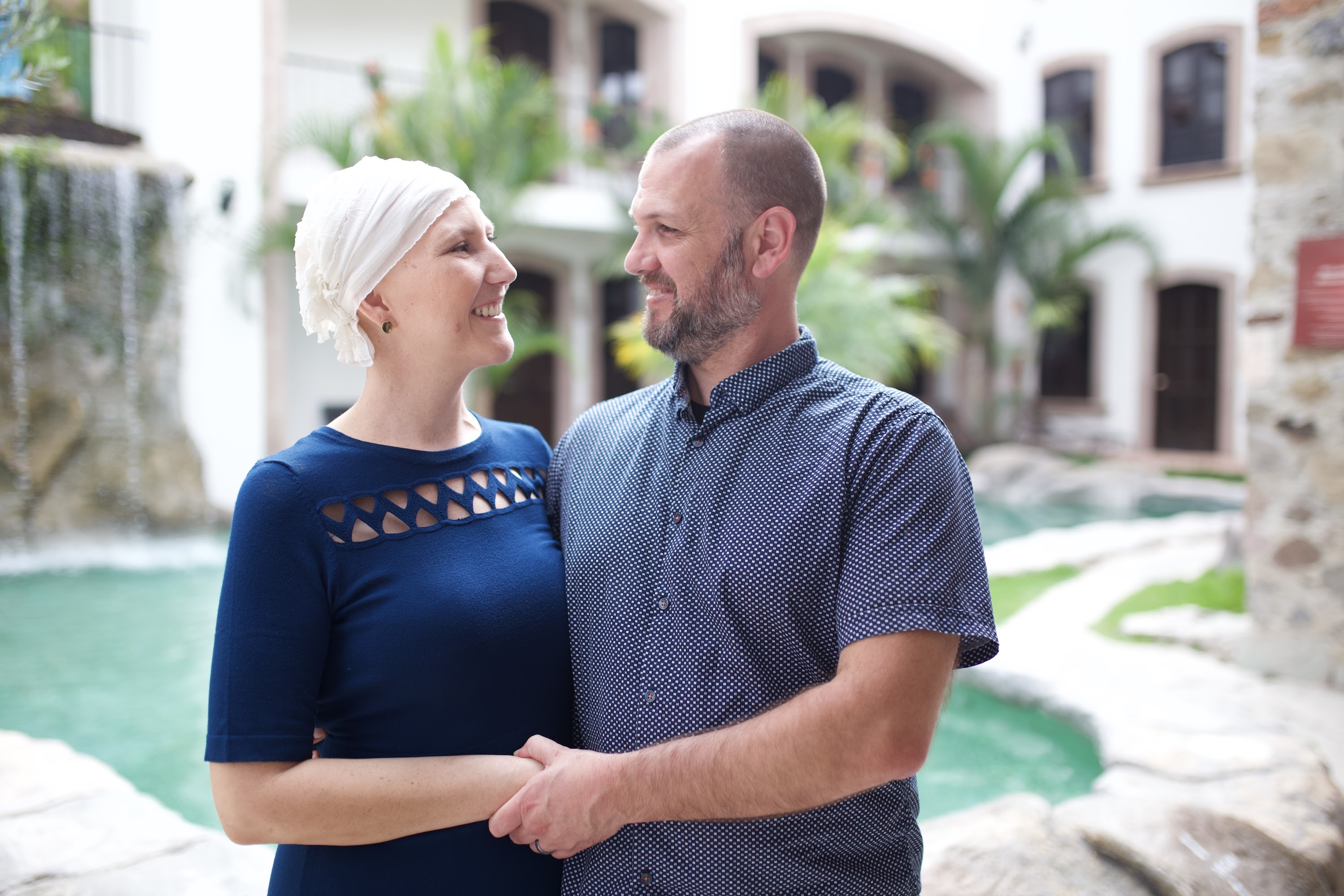 Smiling Couple Embracing Near Water Feature