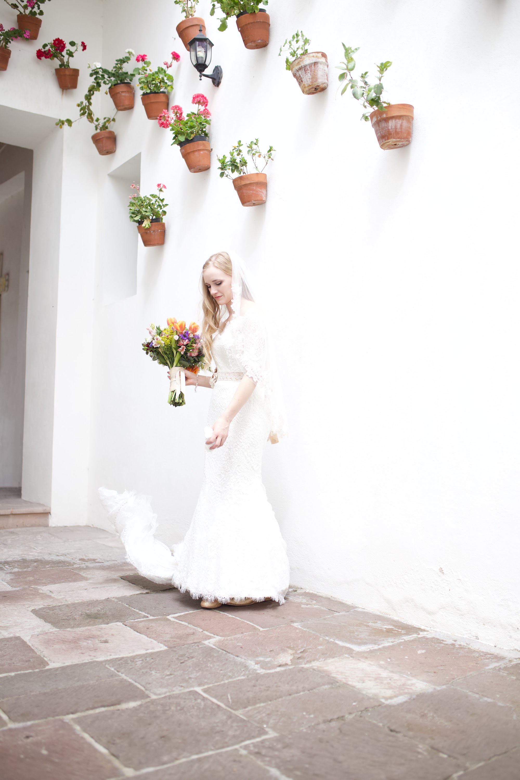 Bride in White Lace Dress Holding Colorful Bouquet
