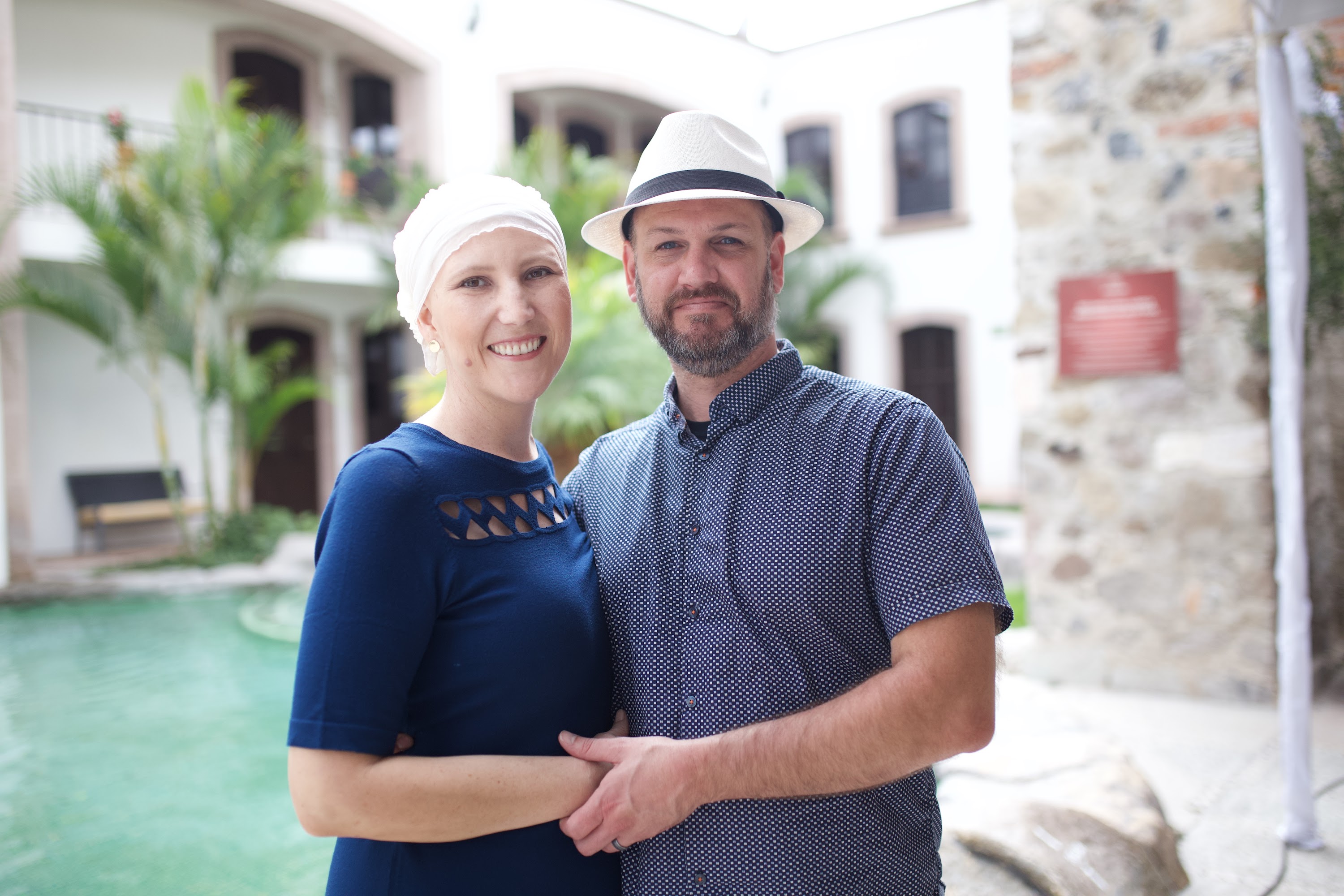 Couple Posed by Poolside in Historic Courtyard