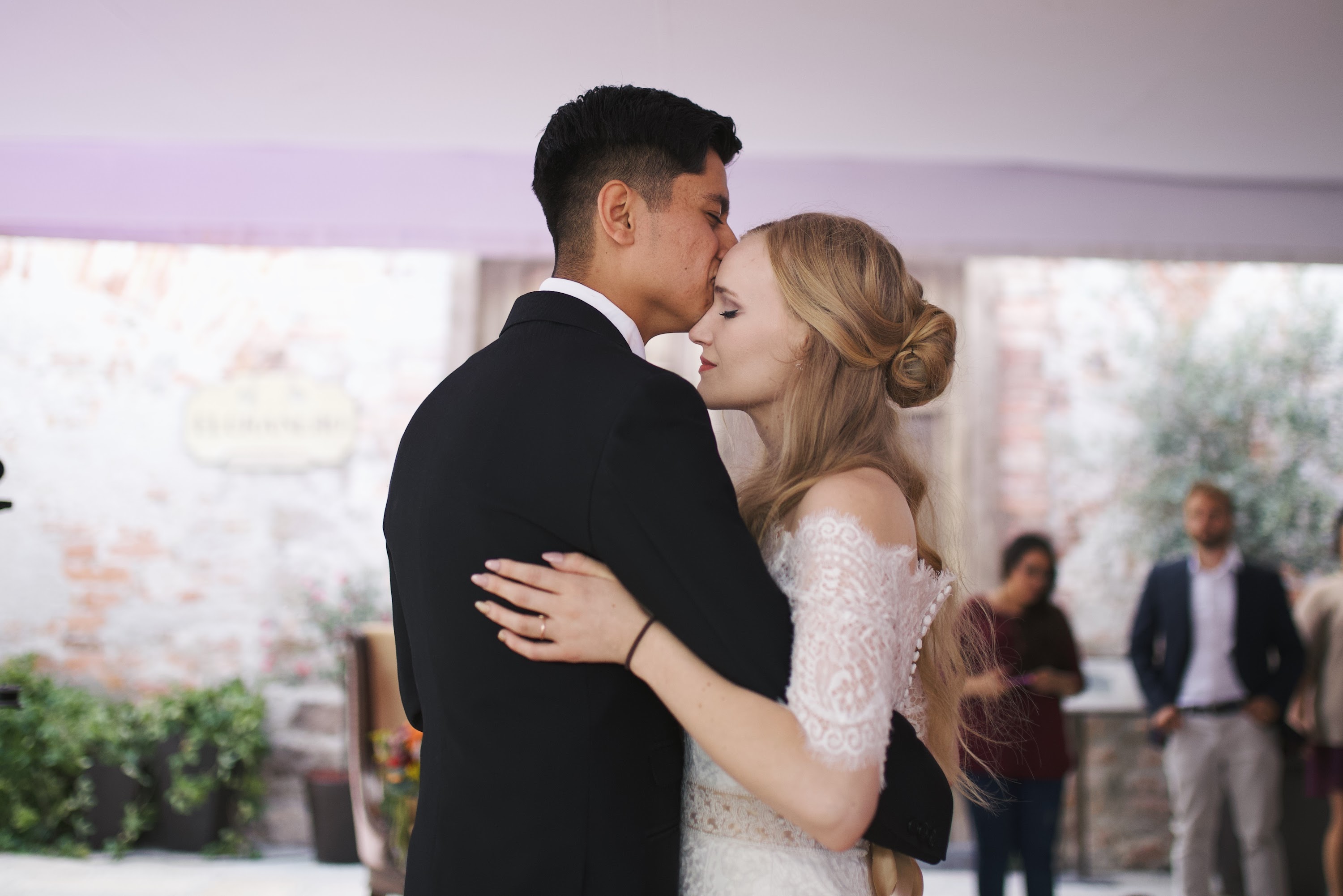 Bride and Groom Sharing a Tender Moment at Wedding Reception