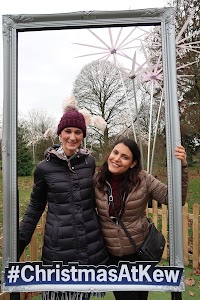Two Women Posing in a Photo Frame at Christmas At Kew
