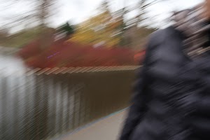Blurred Motion of a Person Walking Near a Fence