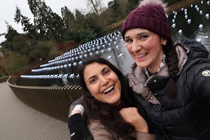 Two Women Smiling by a Star-Filled Pond
