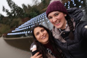 Two Women Taking a Selfie in Front of a Water Feature with Blue Lights