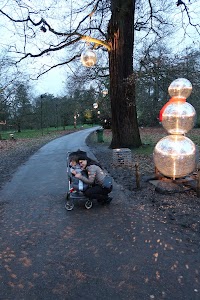 Mother and Child by Illuminated Snowman in Park