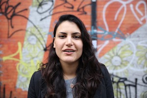 Woman Standing in Front of Graffiti Wall