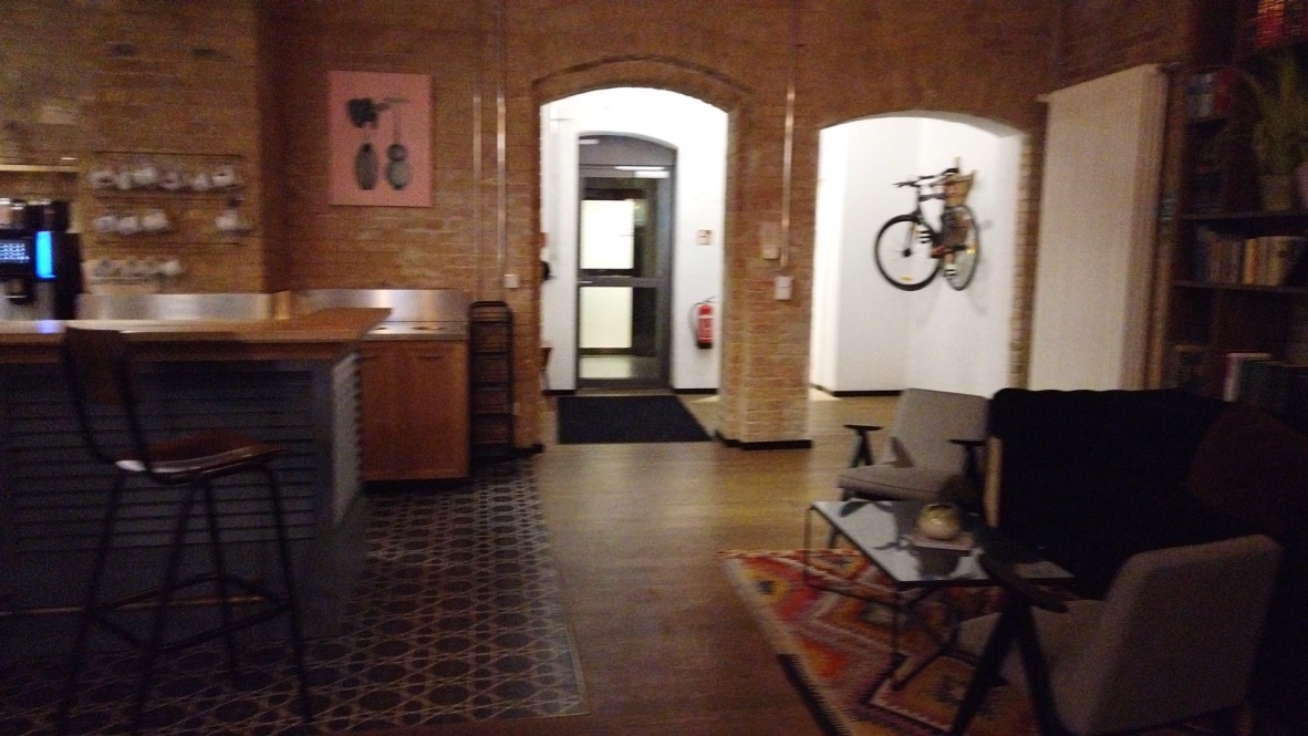 Cozy Lounge Area with Brick Walls and Vintage Bicycle