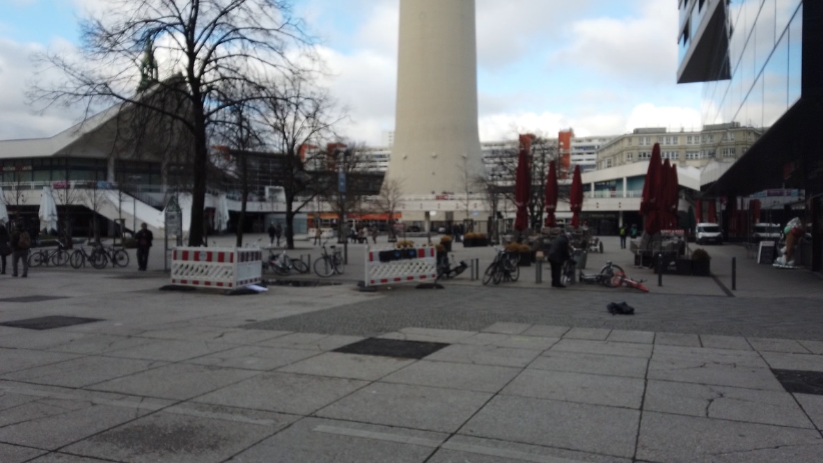 Berlin TV Tower Plaza with Bicycles and Red Umbrellas