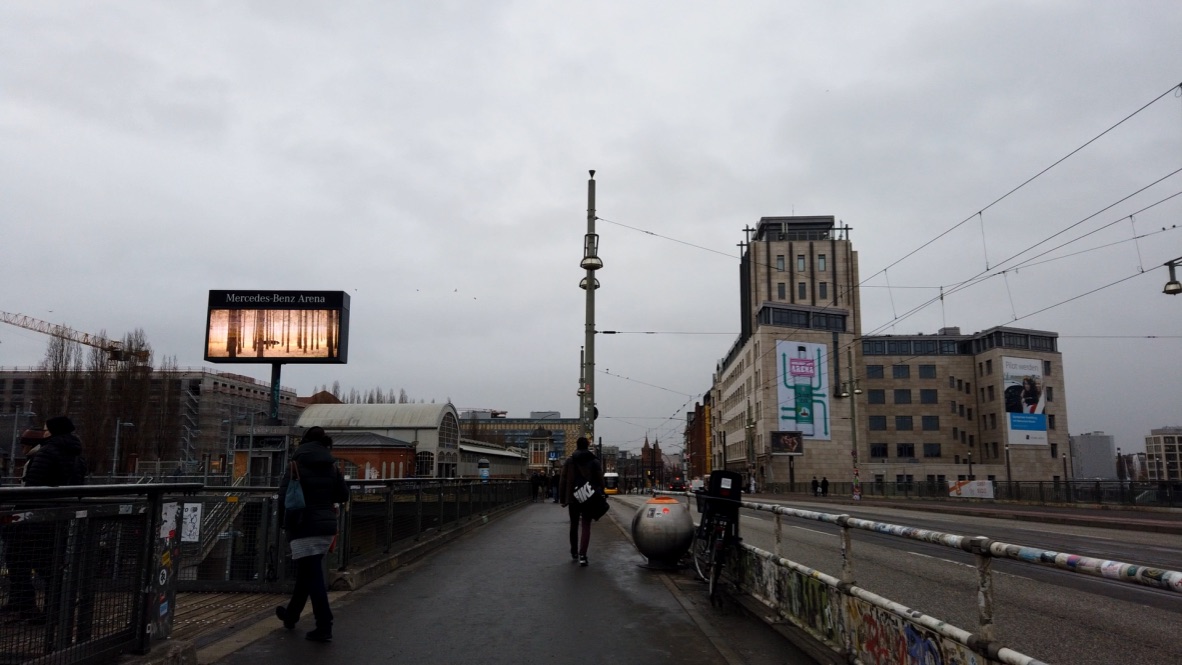 People Walking on Bridge Near Mercedes-Benz Arena in Berlin