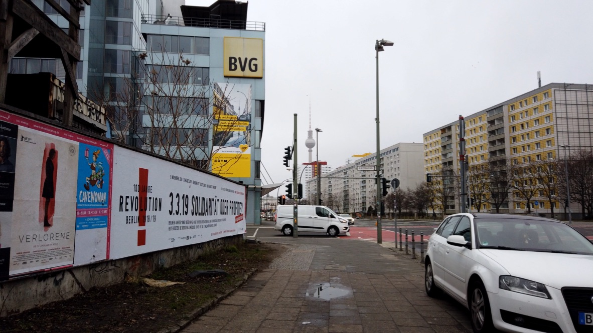 Berlin street scene with BVG building and protest banner