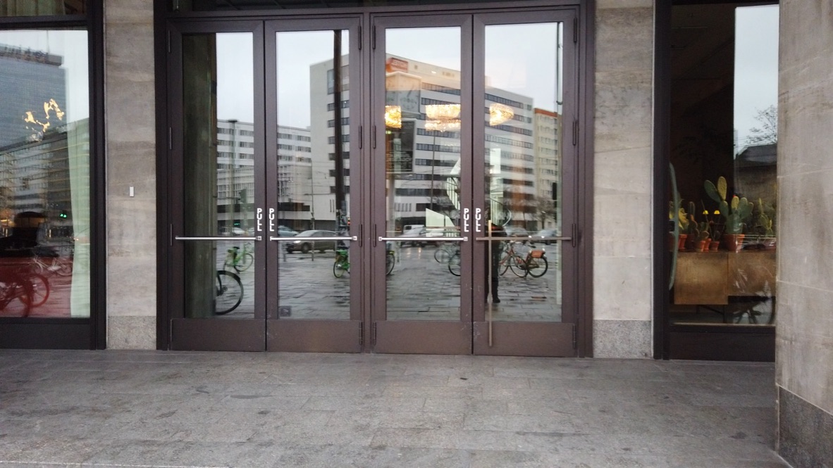 Glass Doors Reflecting City Street and Bicycles