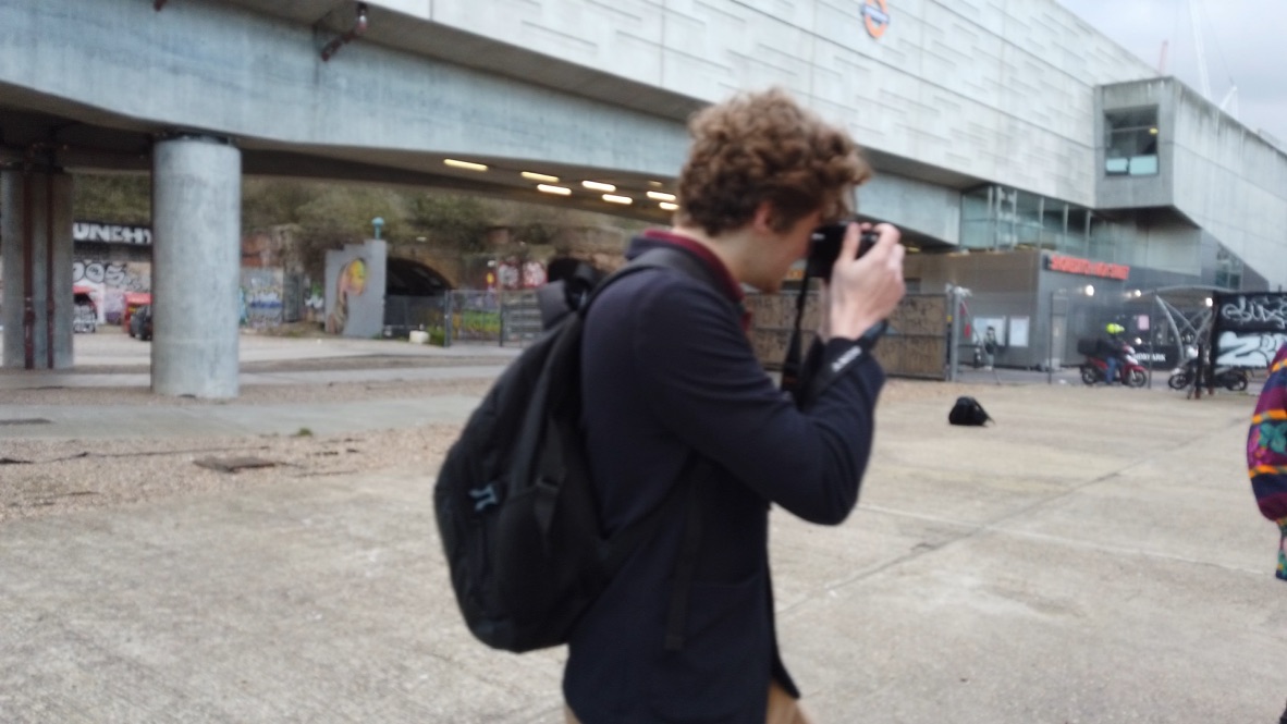 Man Taking Photo Under Concrete Overpass