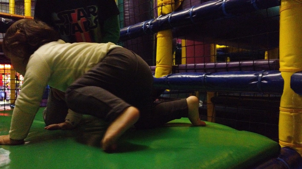Child Crawling in Indoor Play Area