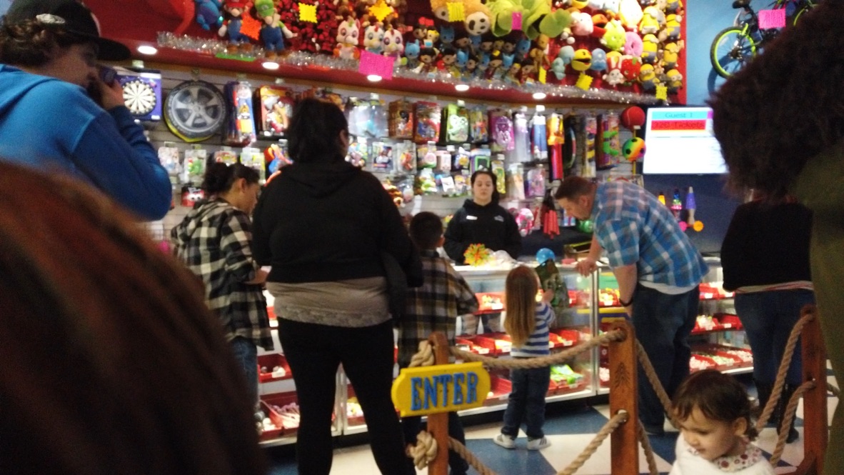 Family at Arcade Game Store Counter