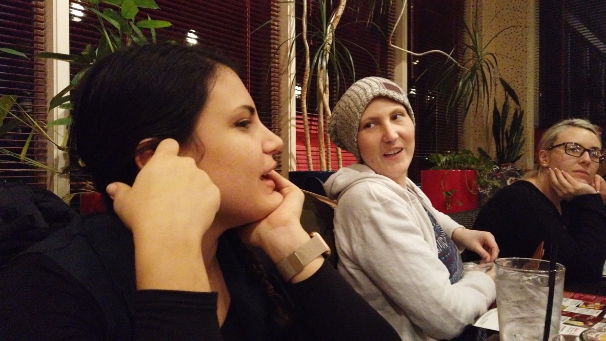 Three Women Enjoying Dinner at a Restaurant