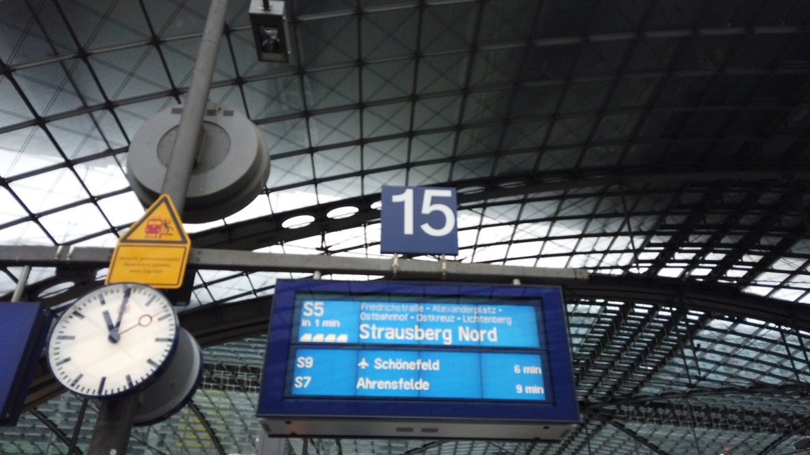 Train station platform 15 with digital departure board and analog clock