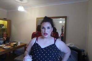 Woman in Polka Dot Dress Holding a Glass