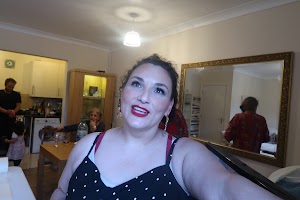 Self-Portrait of Woman with Red Lipstick in Home Setting